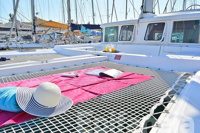 Catamaran cruise in Mykonos with Meal, Drinks & Transport - Rhenia cove swim time, snorkel, and the onboard meal