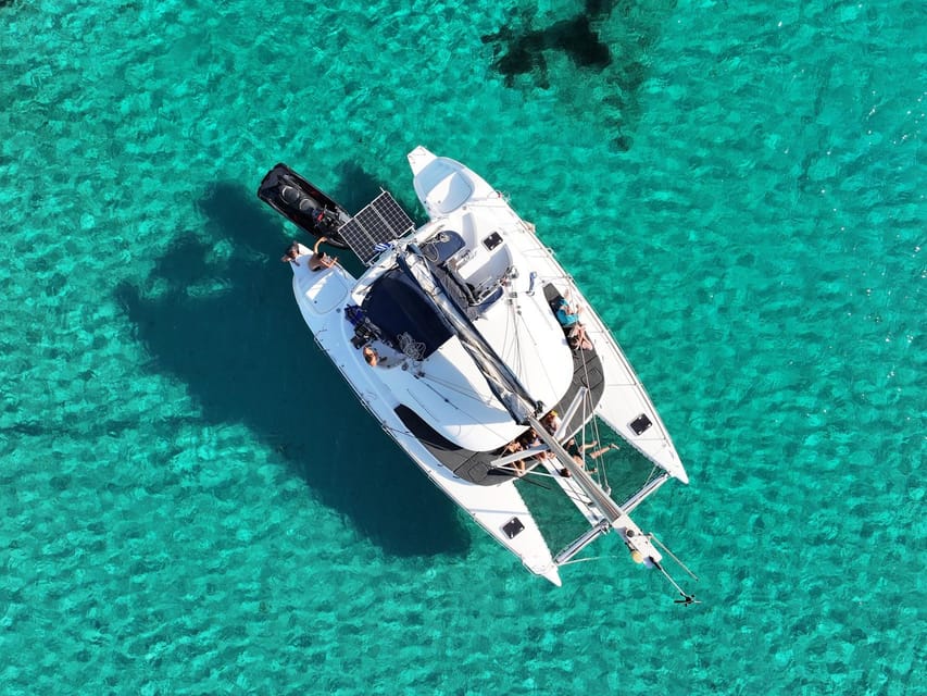 From Ornos: Mykonos Delos Catamaran Cruise with Meal & SUP - Mykonos on the way back: windmills, town views, and easy sightseeing